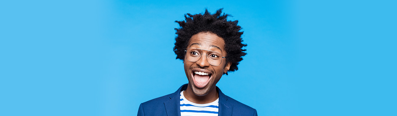 Student smiling with blue background
